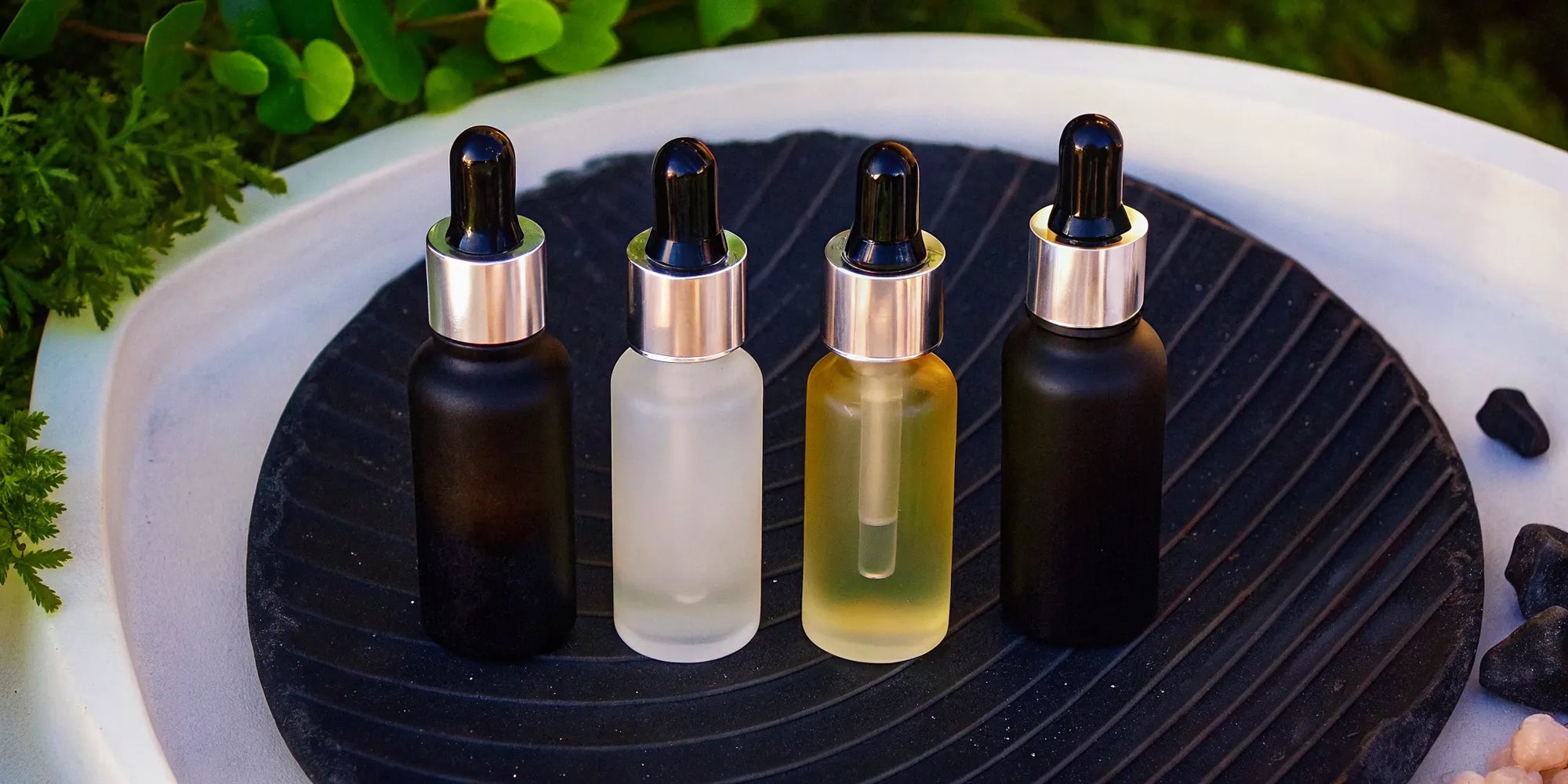 A collection of the best face oils for dry skin in glass dropper bottles.